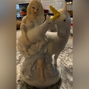 This is a vintage Arimark musical figurine of a woman and two unicorns.